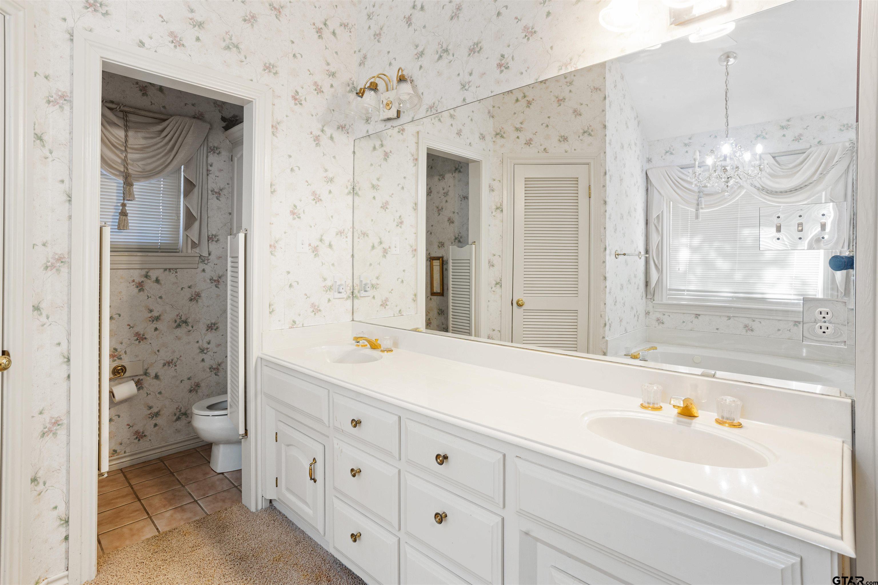 1701 Tall Timber Drive Flint, TX 75762 - Photo 30 of 40 a bathroom with a double vanity sink mirror and a bathtub