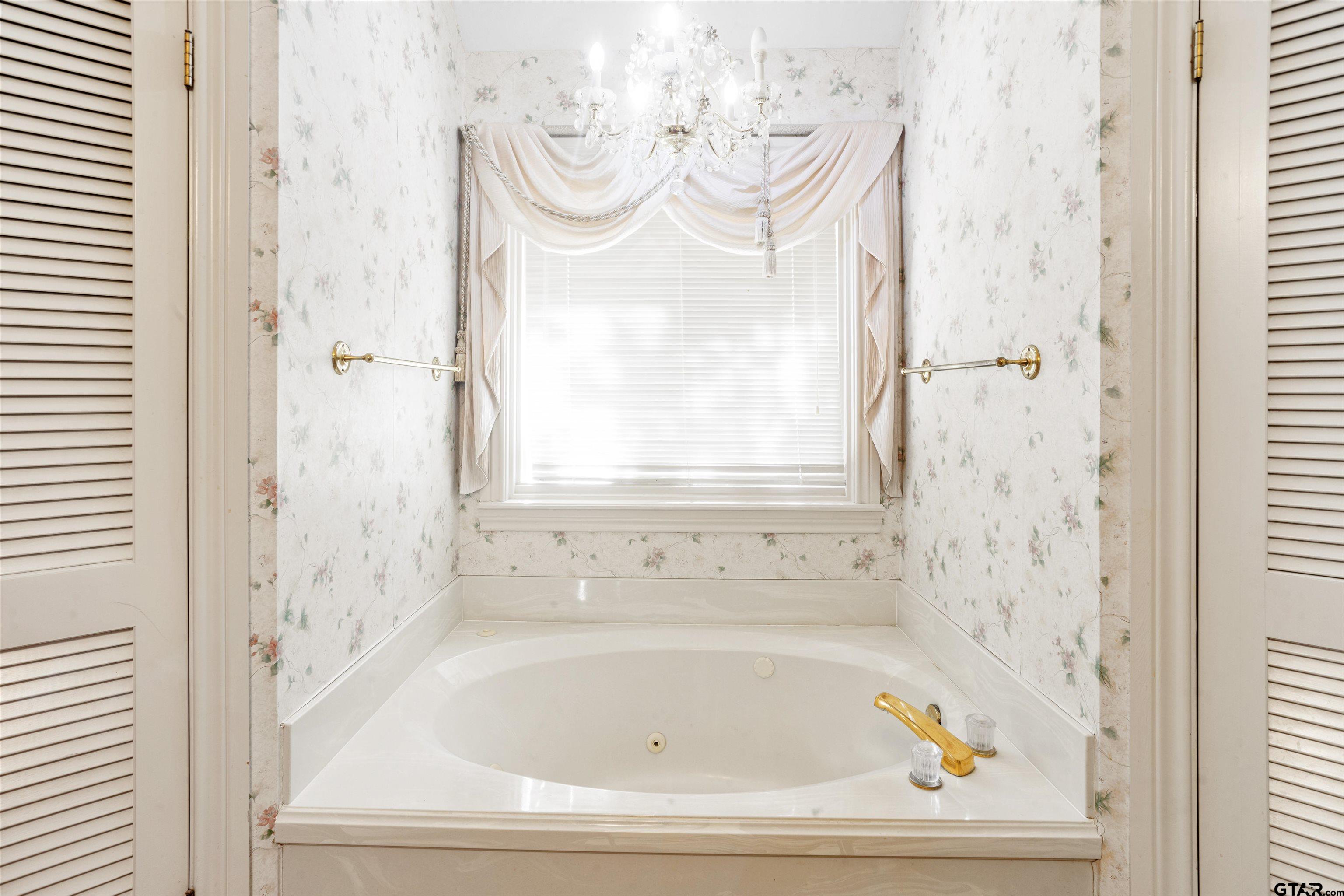 1701 Tall Timber Drive Flint, TX 75762 - Photo 31 of 40 a bathroom with a bathtub and a window
