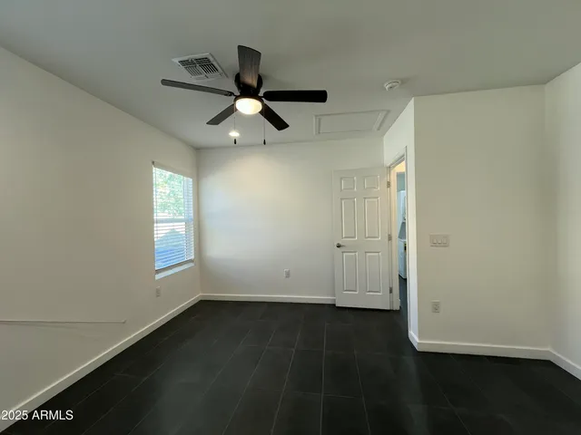 an empty room with wooden floor and cabinet
