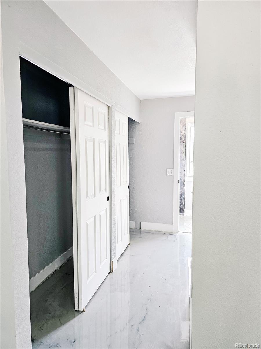 4716 Freeport Way Denver, CO 80239 - Photo 11 of 29 a view of an empty room with closet and a window