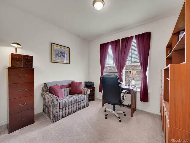 a view of a livingroom with workspace and a couch
