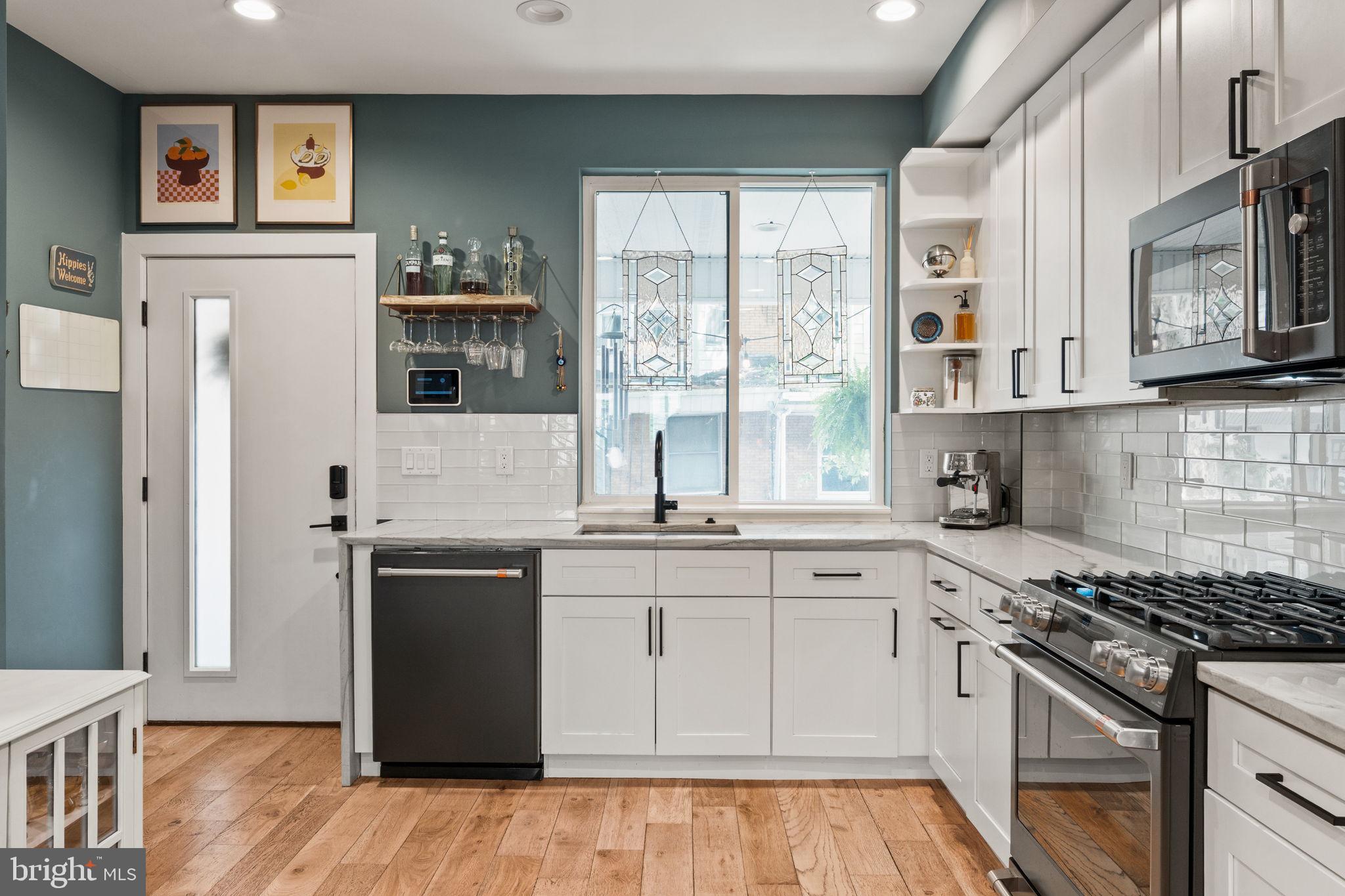 2932 Nicholas Street Philadelphia, PA 19121 - Photo 14 of 65 a kitchen with stainless steel appliances granite countertop a stove a sink and a refrigerator