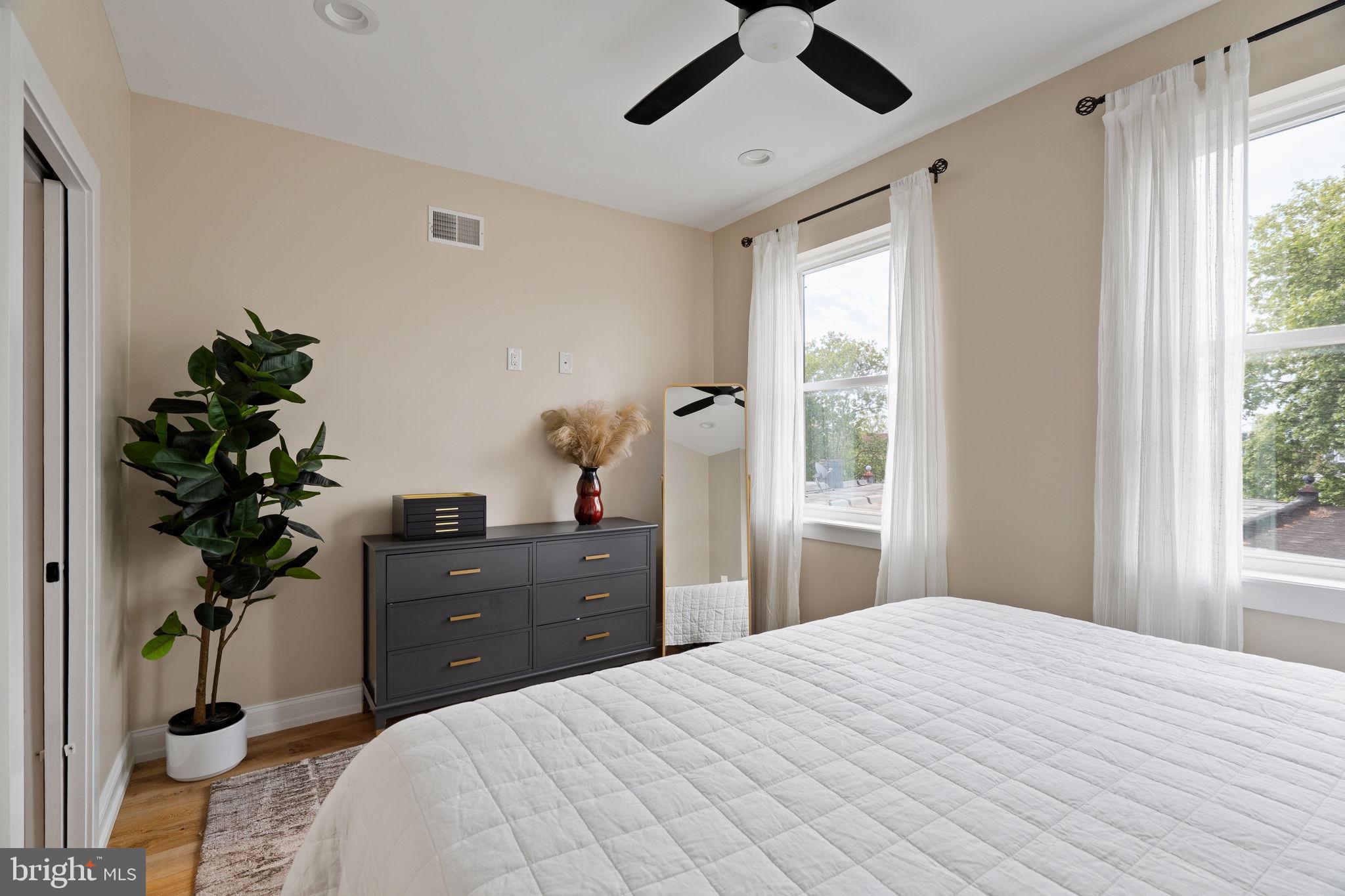 2932 Nicholas Street Philadelphia, PA 19121 - Photo 30 of 65 a bedroom with a bed and a potted plant