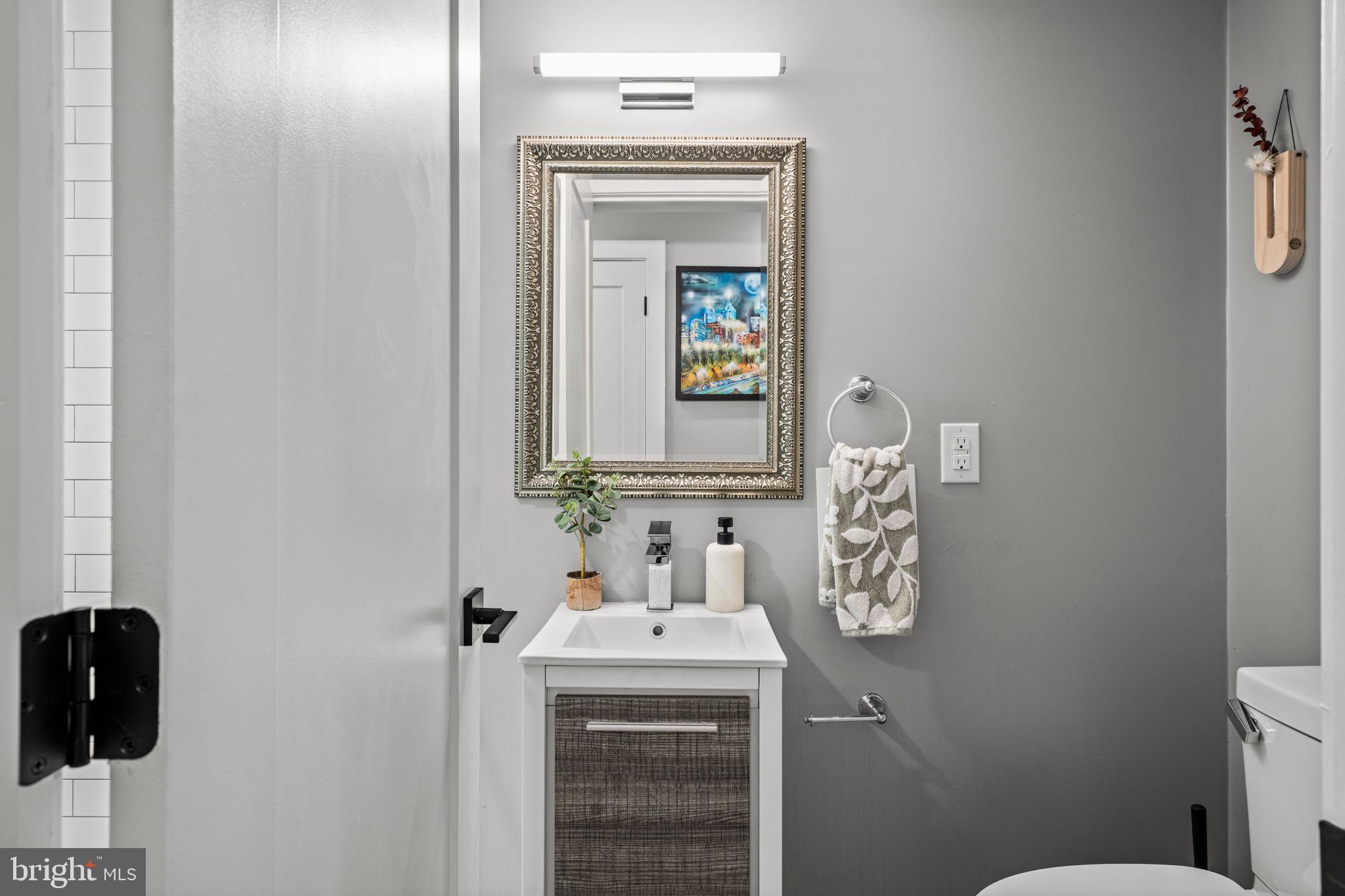 2932 Nicholas Street Philadelphia, PA 19121 - Photo 56 of 65 a bathroom with a sink and a mirror