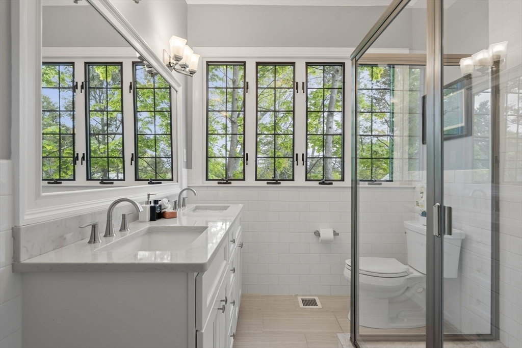 165 Park Avenue, Unit 165 Arlington, MA 02476 - Photo 14 of 32 a bathroom with a sink and mirror with bathtub