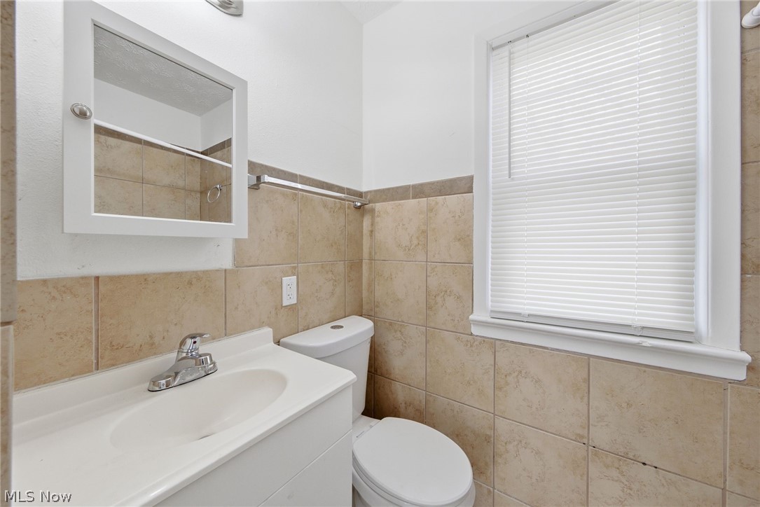 20705 Hansen Road Maple Heights, OH 44137 - Photo 11 of 24 Full bath featuring vanity, tile walls, and a shower
