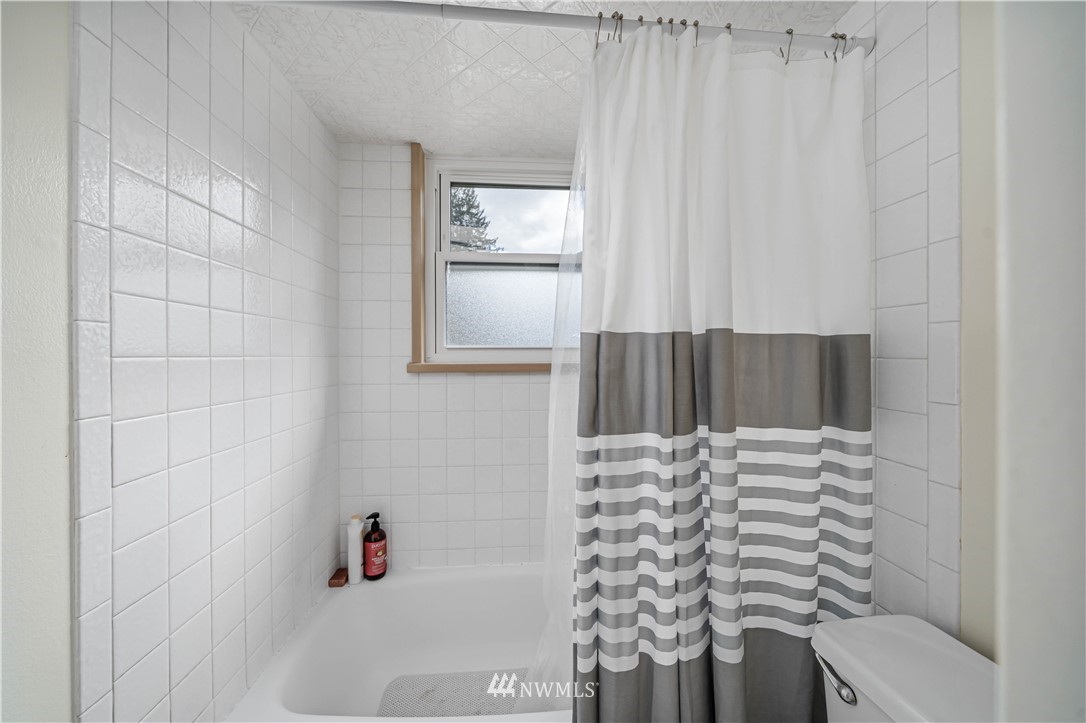 18003 Rhodes Lake Road East Bonney Lake, WA 98391 - Photo 11 of 40 a bathroom with a bathtub and shower