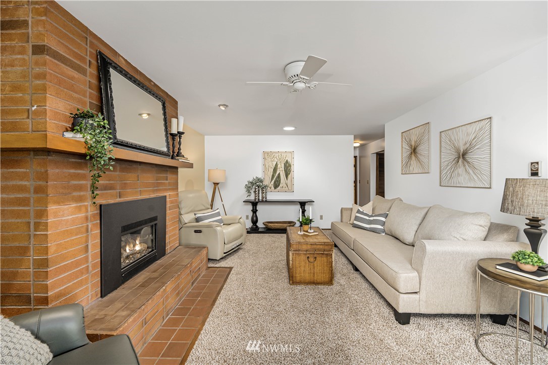 18003 Rhodes Lake Road East Bonney Lake, WA 98391 - Photo 21 of 40 a living room with furniture and a fireplace