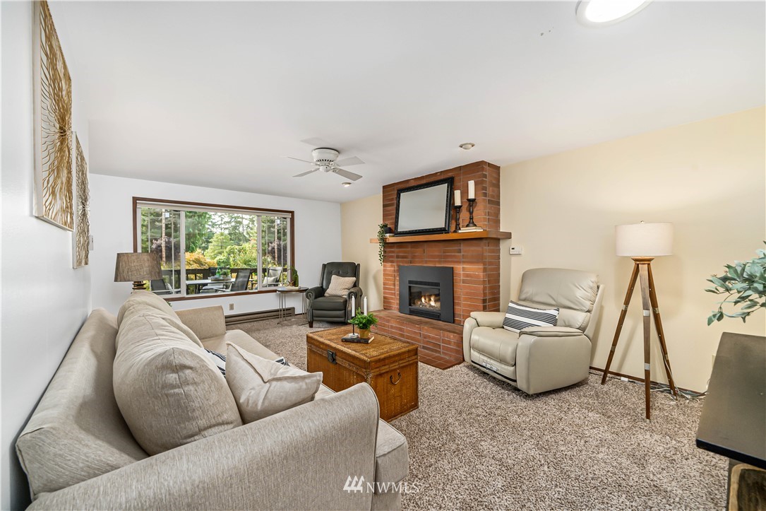 18003 Rhodes Lake Road East Bonney Lake, WA 98391 - Photo 22 of 40 a living room with furniture and a fireplace