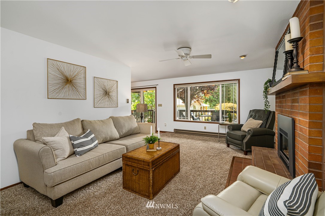 18003 Rhodes Lake Road East Bonney Lake, WA 98391 - Photo 23 of 40 a living room with furniture and a fireplace