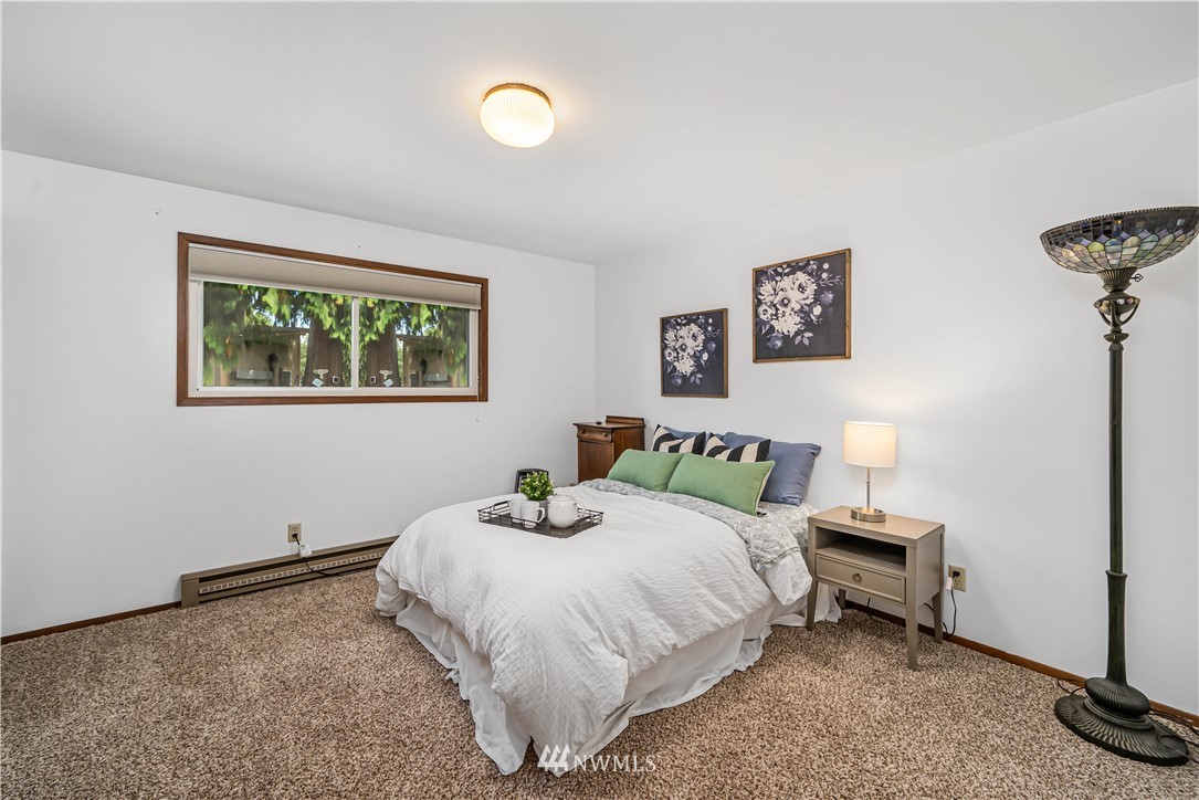 18003 Rhodes Lake Road East Bonney Lake, WA 98391 - Photo 24 of 40 a bedroom with a bed and a wall painting