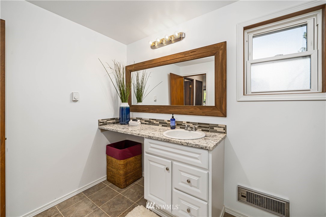 18003 Rhodes Lake Road East Bonney Lake, WA 98391 - Photo 27 of 40 a bathroom with a toilet sink and mirror