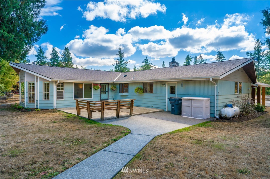 18003 Rhodes Lake Road East Bonney Lake, WA 98391 - Photo 32 of 40 a view of a house with a patio and a yard
