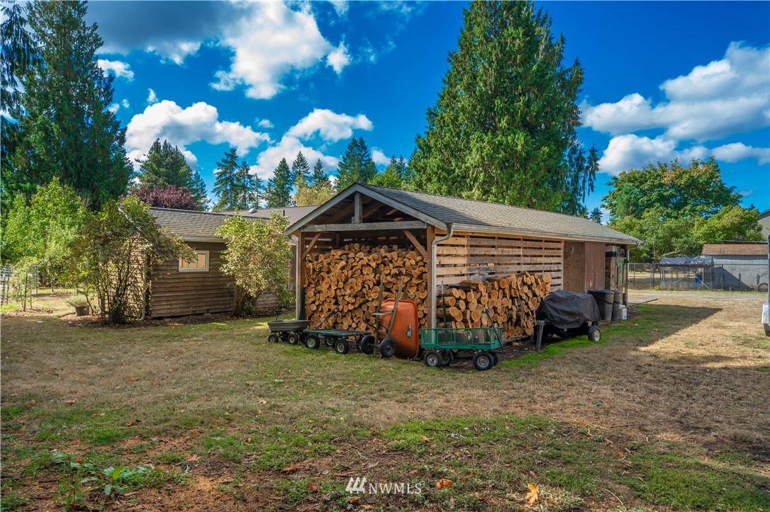 18003 Rhodes Lake Road East Bonney Lake, WA 98391 - Photo 36 of 40 a view of a house with a yard and garage