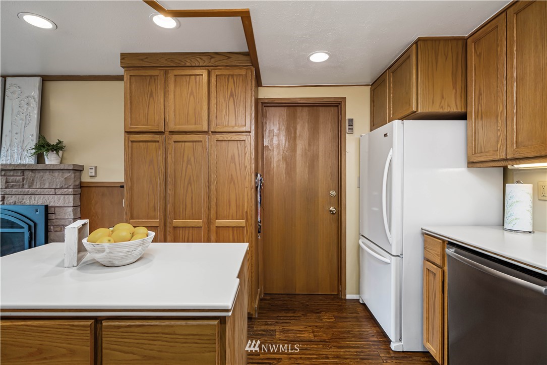 18003 Rhodes Lake Road East Bonney Lake, WA 98391 - Photo 8 of 40 a kitchen with stainless steel appliances a refrigerator and a stove