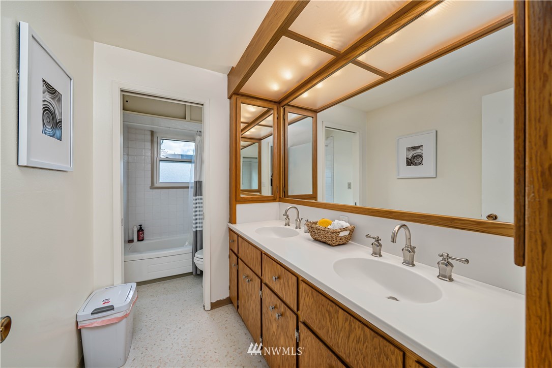 18003 Rhodes Lake Road East Bonney Lake, WA 98391 - Photo 10 of 40 a bathroom with a double vanity sink toilet and mirror