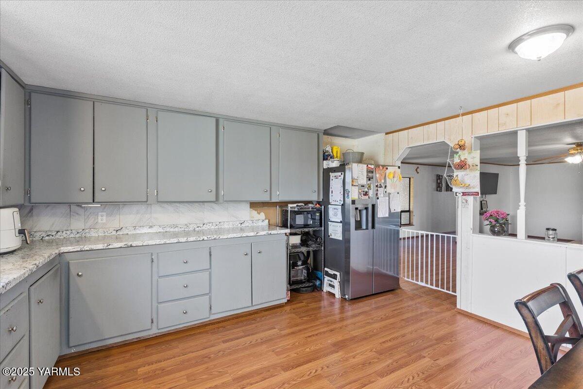 101 West Slavin Road Yakima, WA 98903 - Photo 14 of 37 a kitchen with a sink cabinets and wooden floor