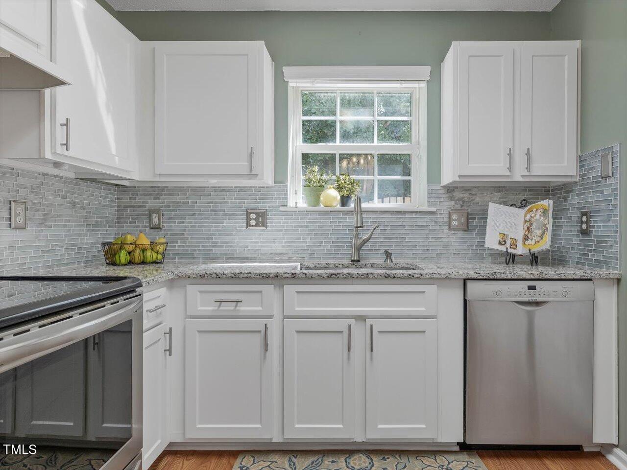 4509 Dolwick Drive Durham, NC 27713 - Photo 10 of 31 a kitchen with granite countertop cabinets stainless steel appliances and a sink