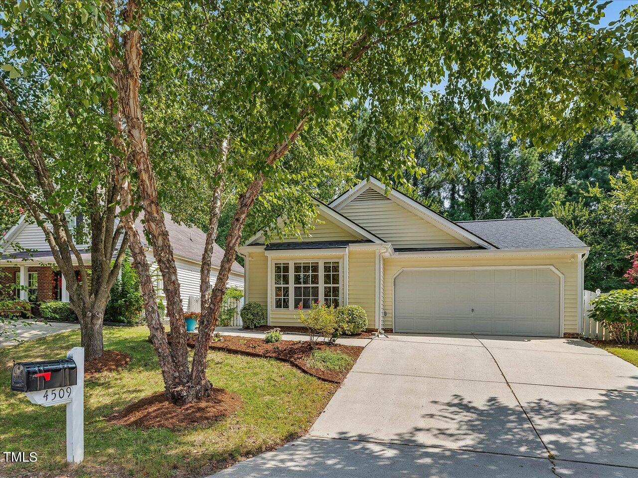 4509 Dolwick Drive Durham, NC 27713 - Photo 2 of 31 a front view of a house with garden