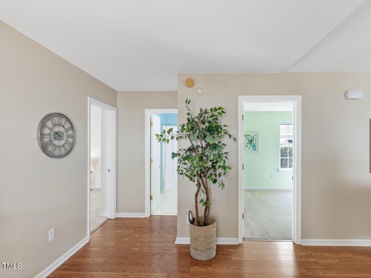 4509 Dolwick Drive Durham, NC 27713 - Photo 20 of 31 a view of a hallway with paintings on the wall