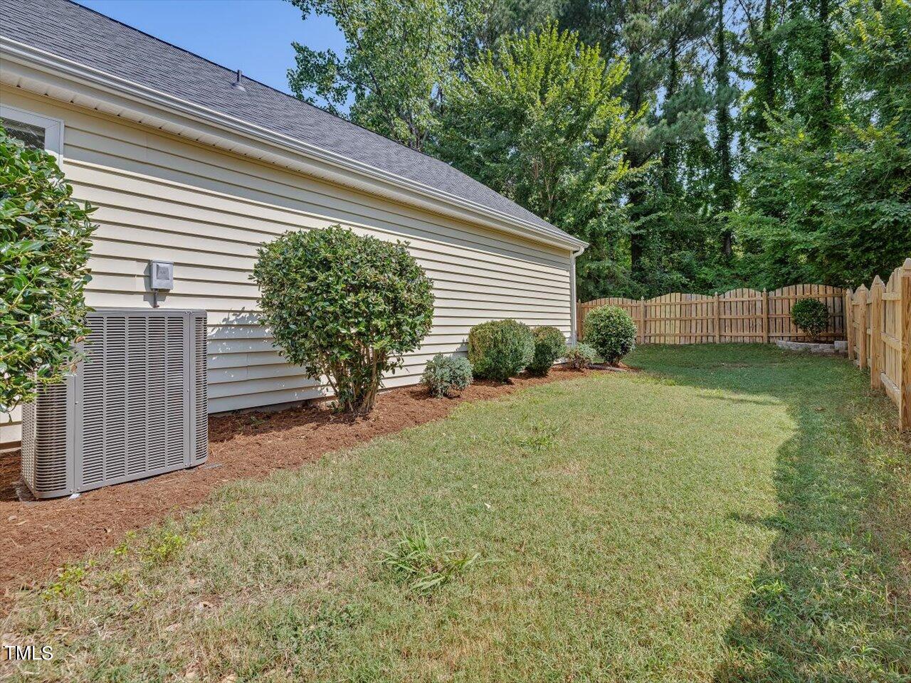 4509 Dolwick Drive Durham, NC 27713 - Photo 29 of 31 a view of a backyard with plants and large trees