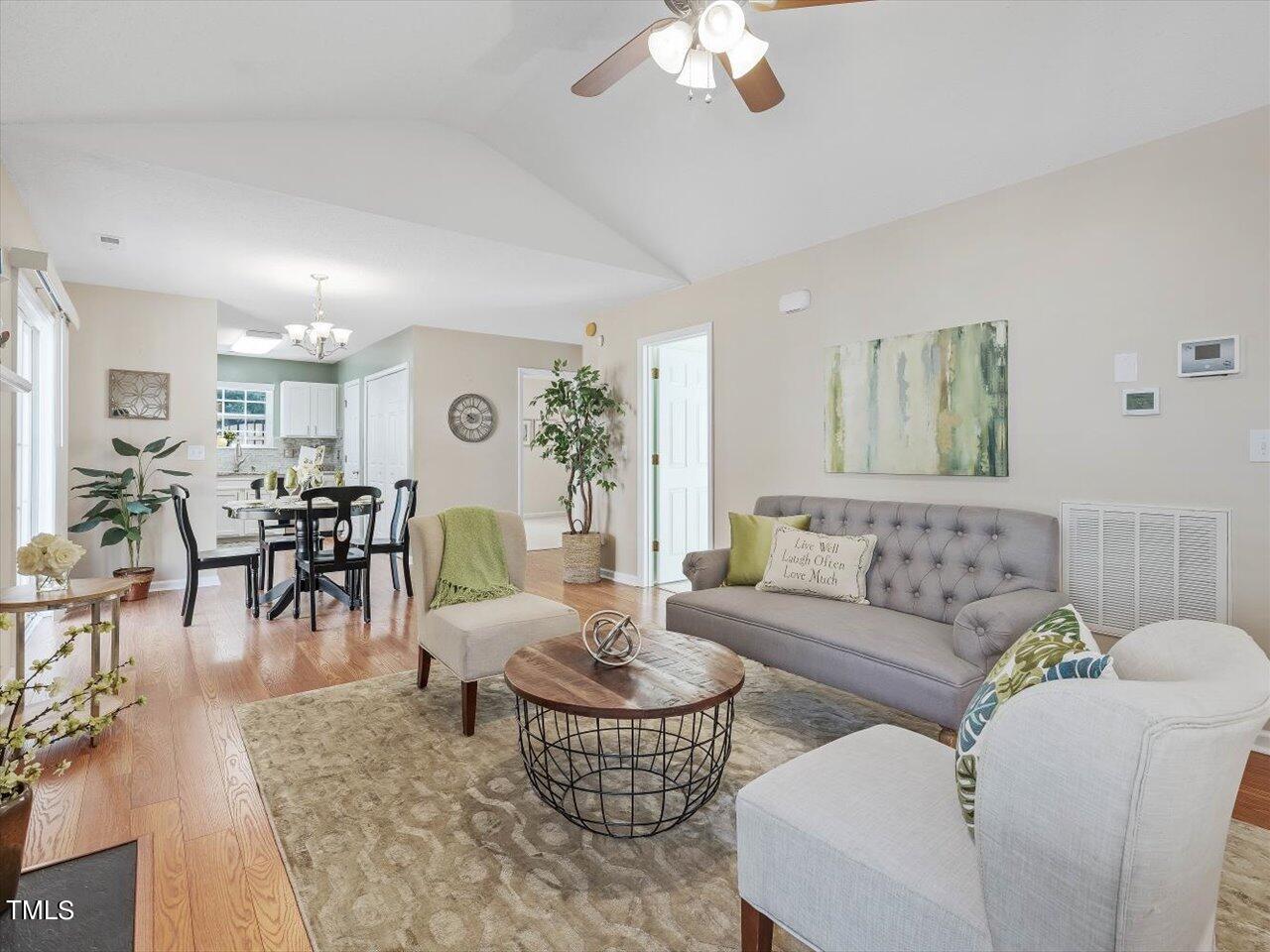 4509 Dolwick Drive Durham, NC 27713 - Photo 30 of 31 a living room with furniture and a chandelier