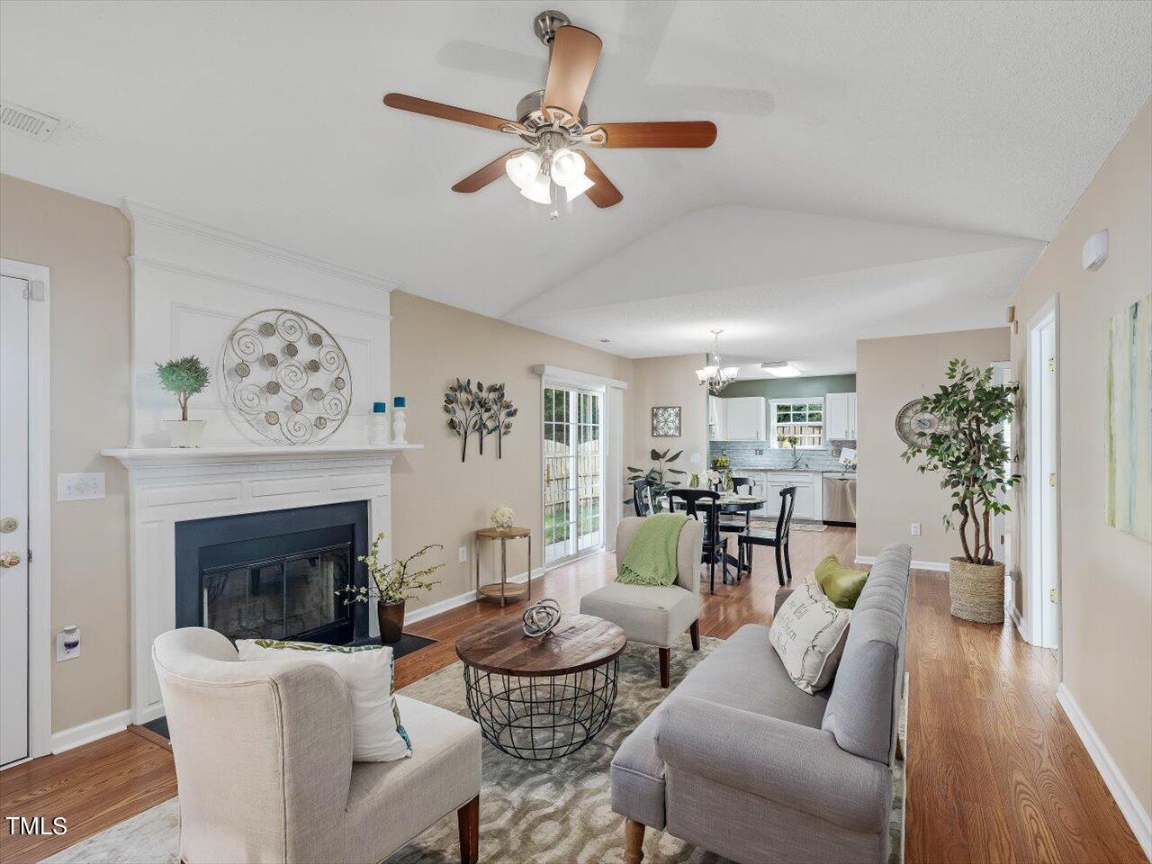 4509 Dolwick Drive Durham, NC 27713 - Photo 31 of 31 a living room with furniture a fireplace and a chandelier