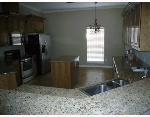 a kitchen with a refrigerator sink and microwave