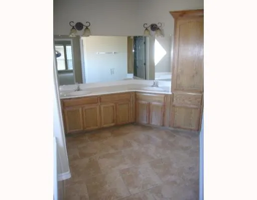 a large bathroom with a sink and a large mirror