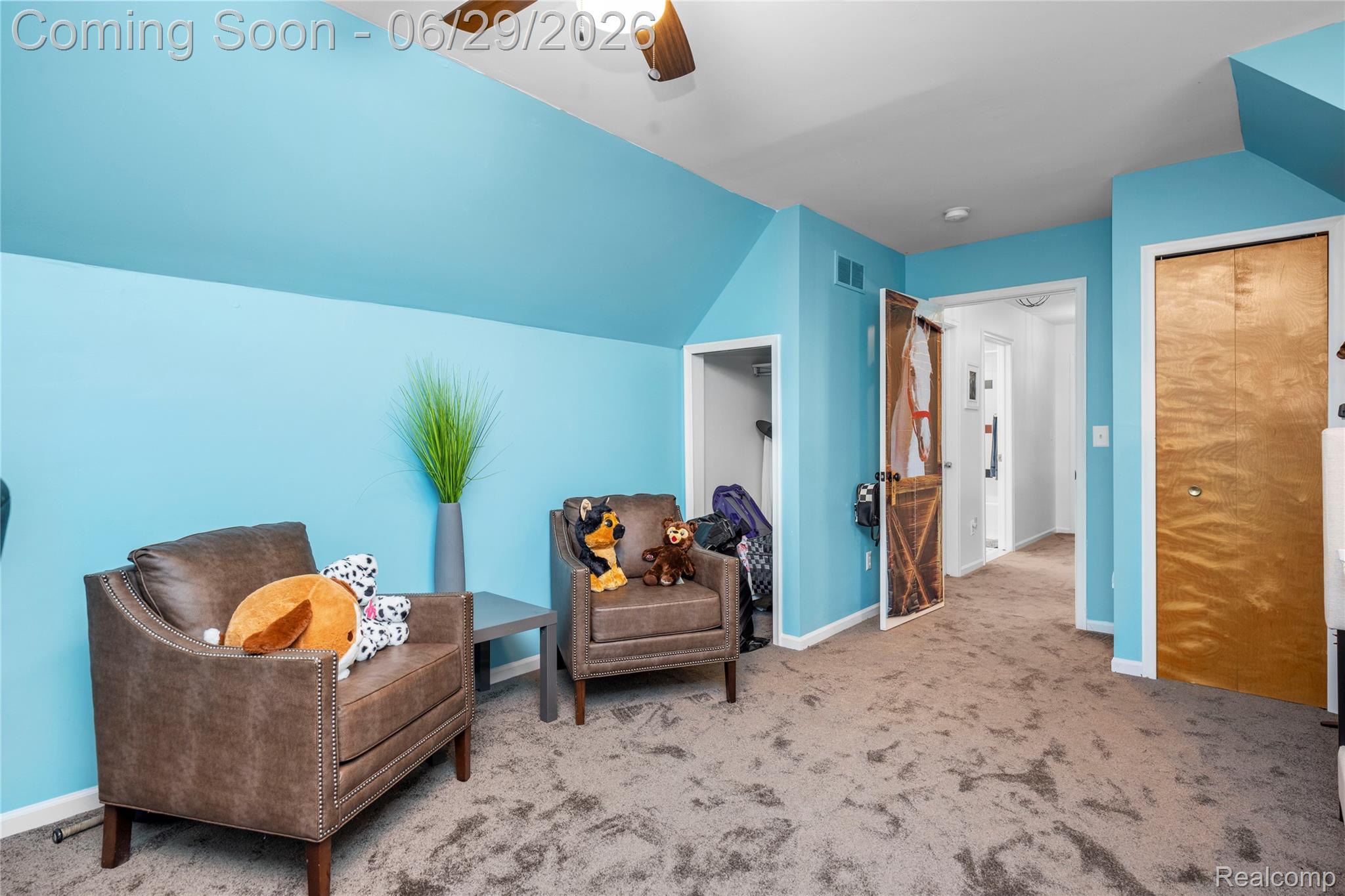 6085 Worlington Road Bloomfield Hills, MI 48301 - Photo 50 of 75 Carpeted room featuring a sloped ceiling and light blue walls, with a ceiling fan overhead
