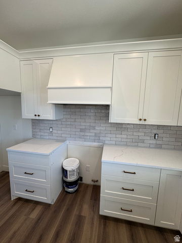 389 West 2100 South Perry, UT 84302 - Photo 14 of 21 White shaker-style cabinetry, light-toned countertop, subway tile backsplash, white range hood, and wood-finish flooring