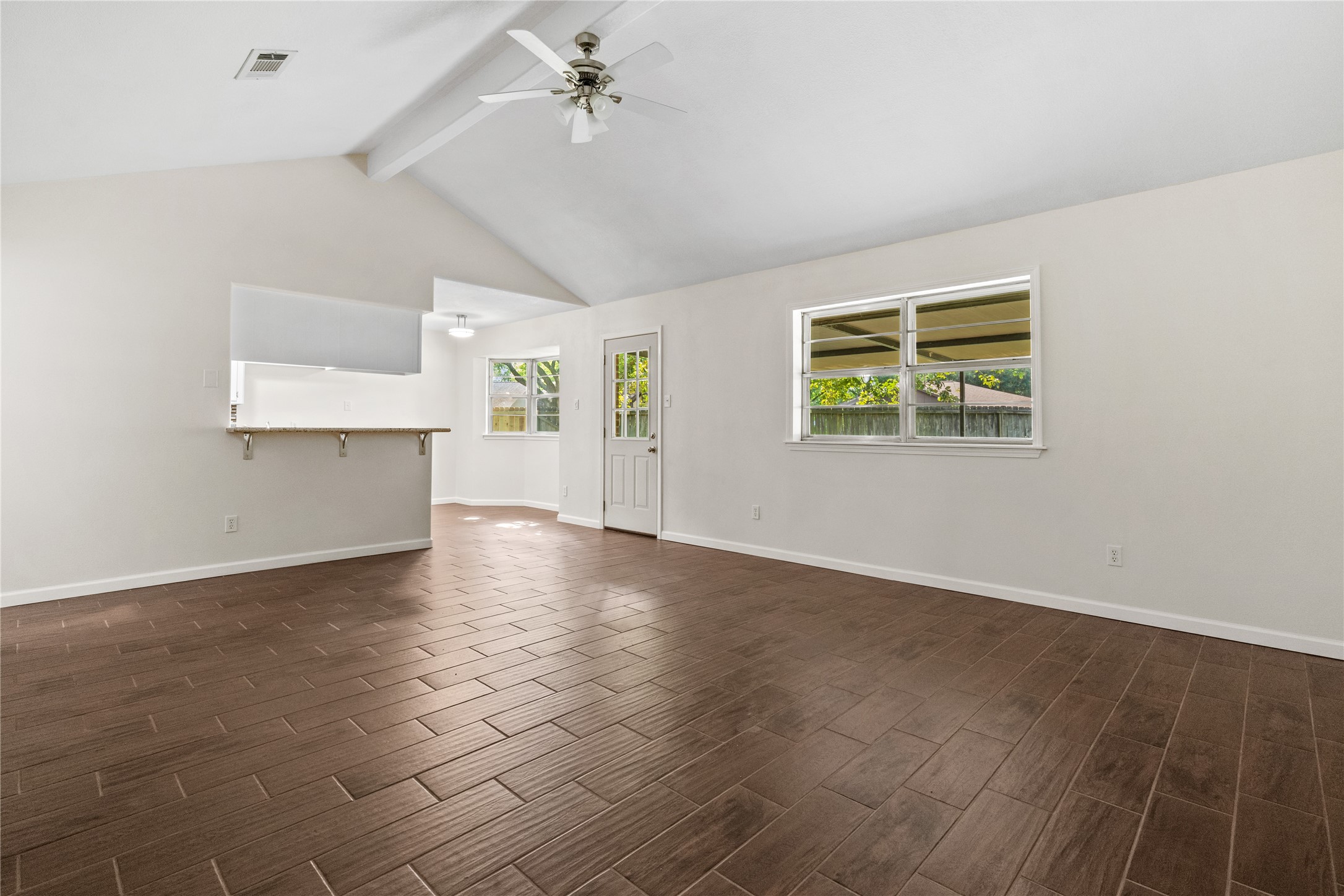 3930 Tumbleweed Lane Baytown, TX 77521 - Photo 4 of 23 an empty room with wooden floor and windows