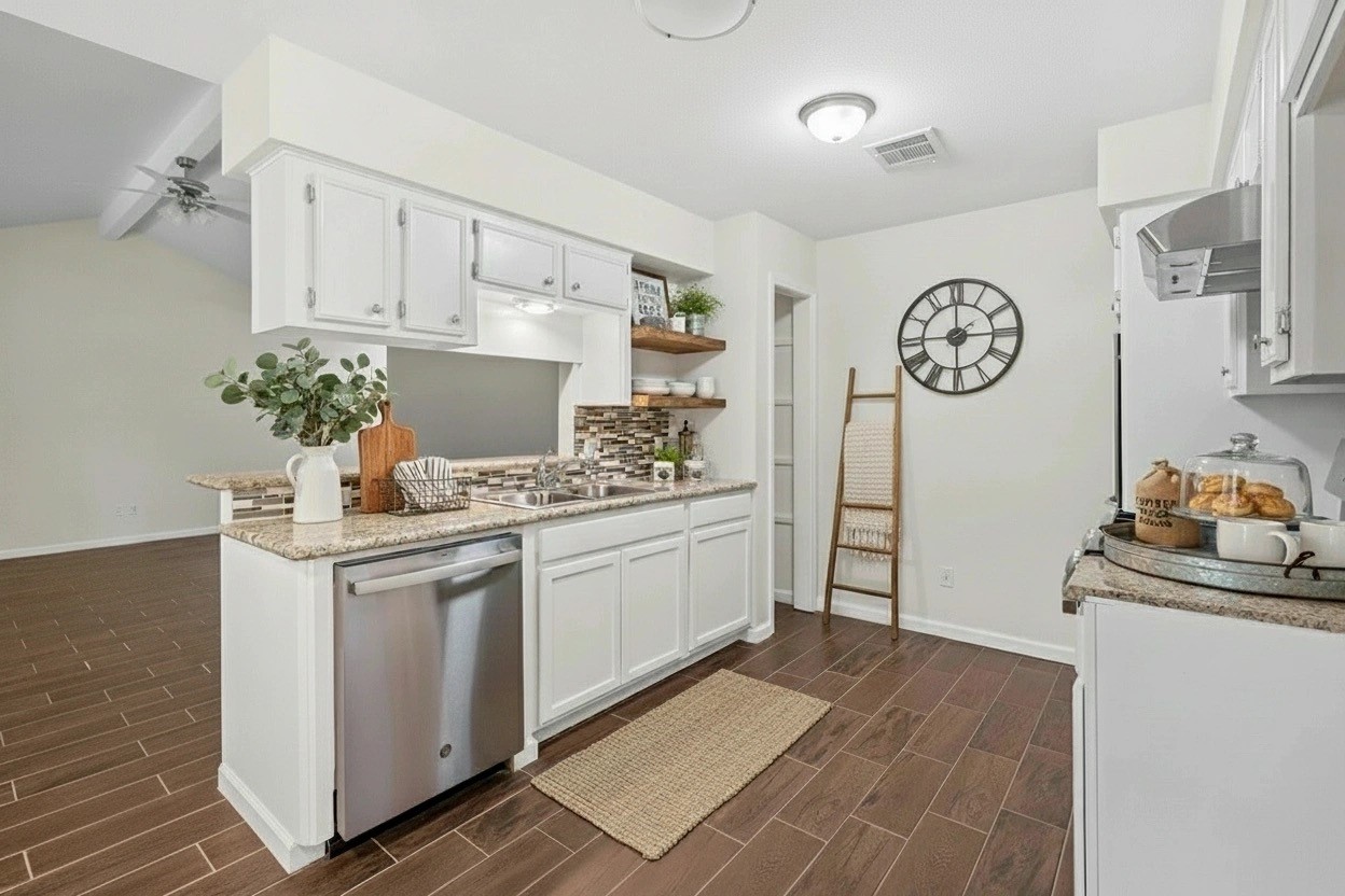 3930 Tumbleweed Lane Baytown, TX 77521 - Photo 5 of 23 a kitchen with stainless steel appliances granite countertop a white cabinets and a stove