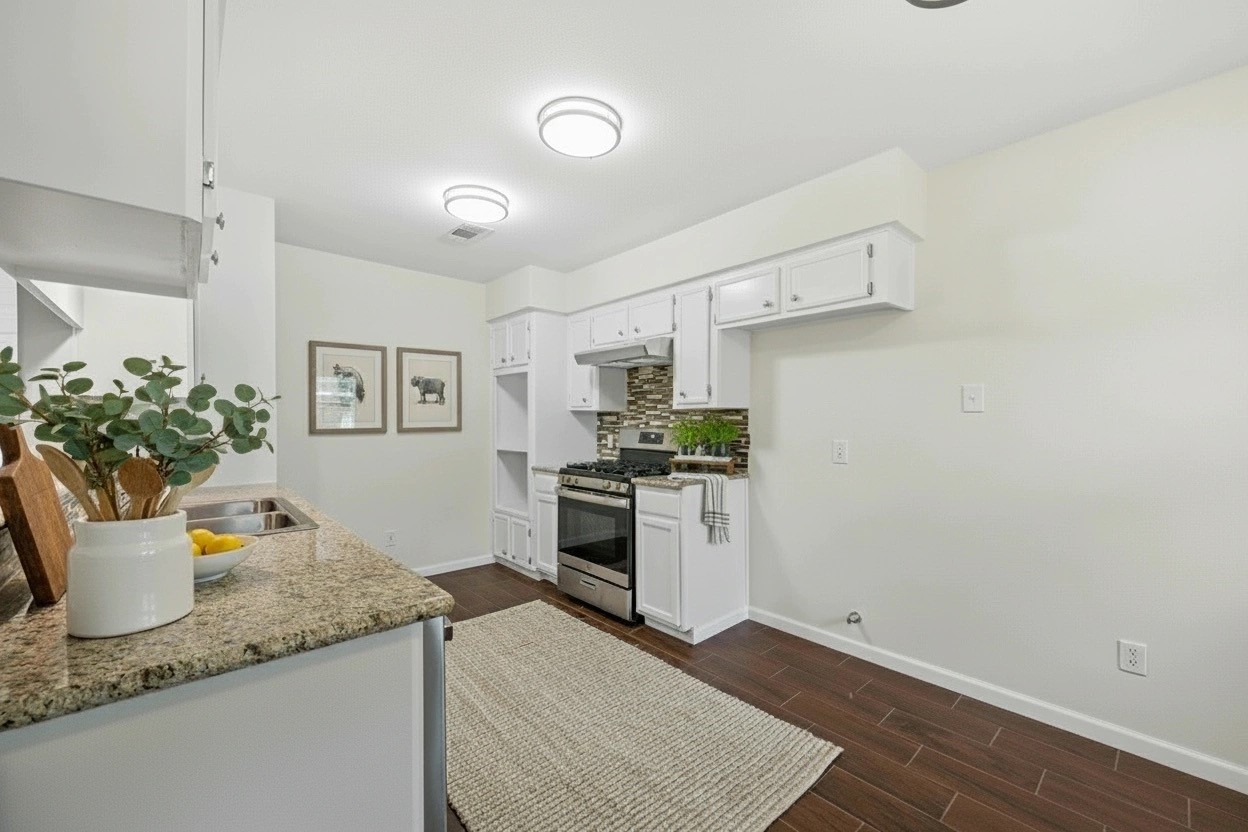 3930 Tumbleweed Lane Baytown, TX 77521 - Photo 6 of 23 a kitchen with a sink and white cabinets