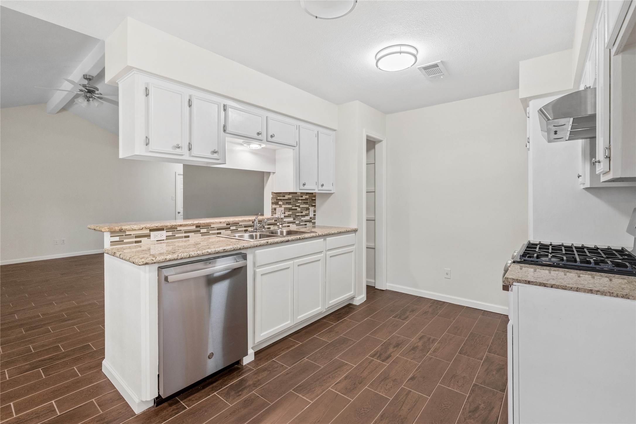 3930 Tumbleweed Lane Baytown, TX 77521 - Photo 7 of 23 a kitchen with white cabinets and white appliances