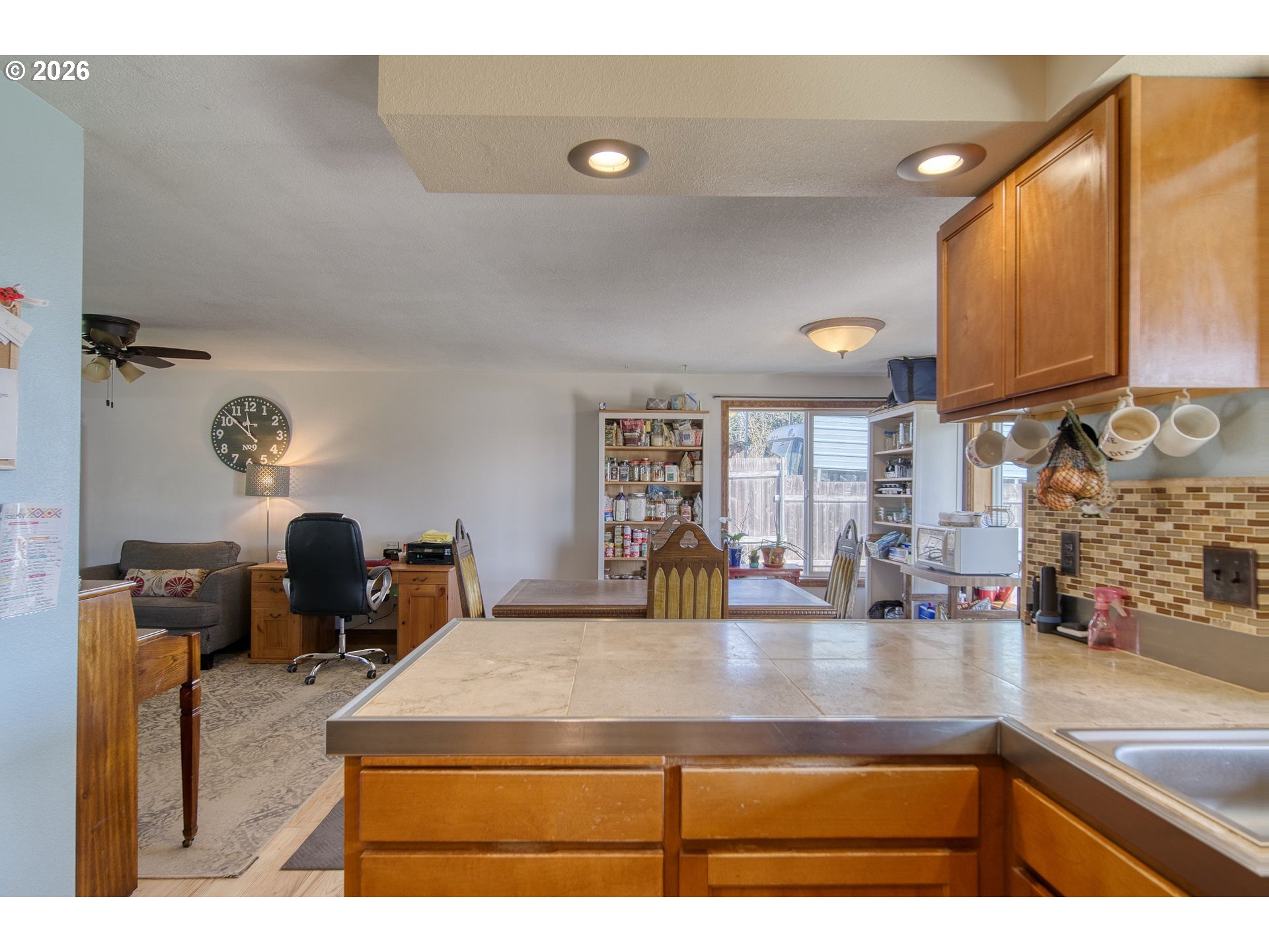 52320 Southwest Taylor Street Scappoose, OR 97056 - Photo 11 of 48 a kitchen with kitchen island a sink a stove and a wooden cabinets