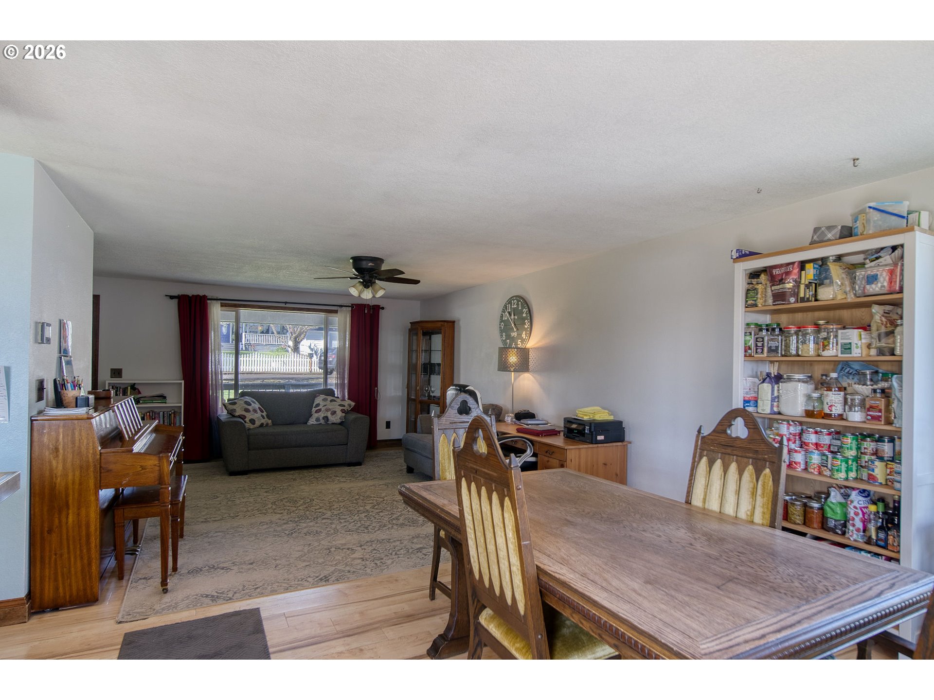 52320 Southwest Taylor Street Scappoose, OR 97056 - Photo 12 of 48 a view of a livingroom and a dining room with furniture window and wooden floor