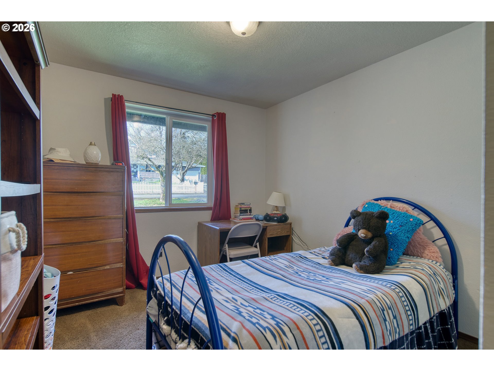 52320 Southwest Taylor Street Scappoose, OR 97056 - Photo 13 of 48 a bedroom with a bed a dresser next to a window