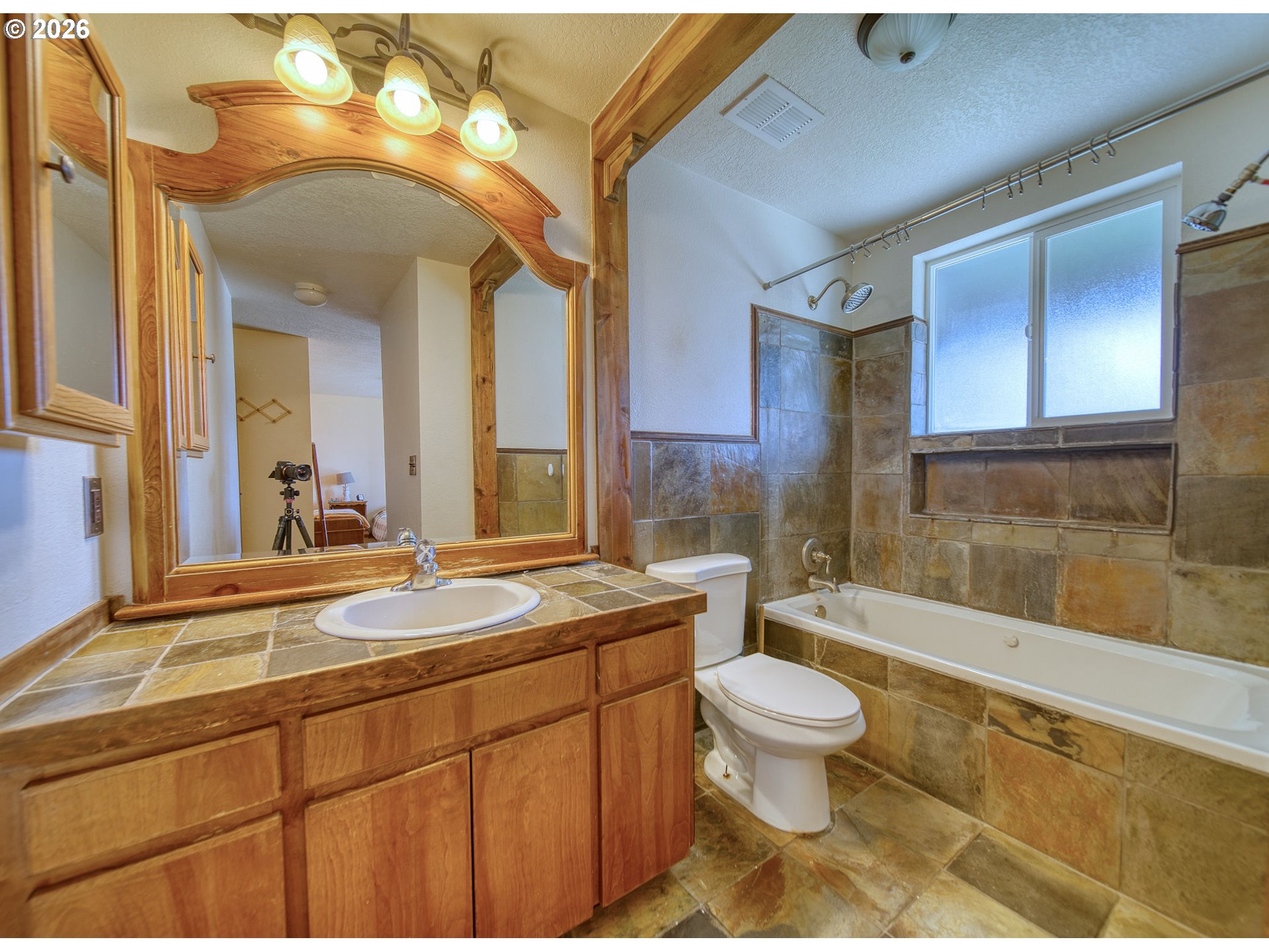 52320 Southwest Taylor Street Scappoose, OR 97056 - Photo 25 of 48 a spacious bathroom with a granite countertop sink a toilet a mirror and bathtub