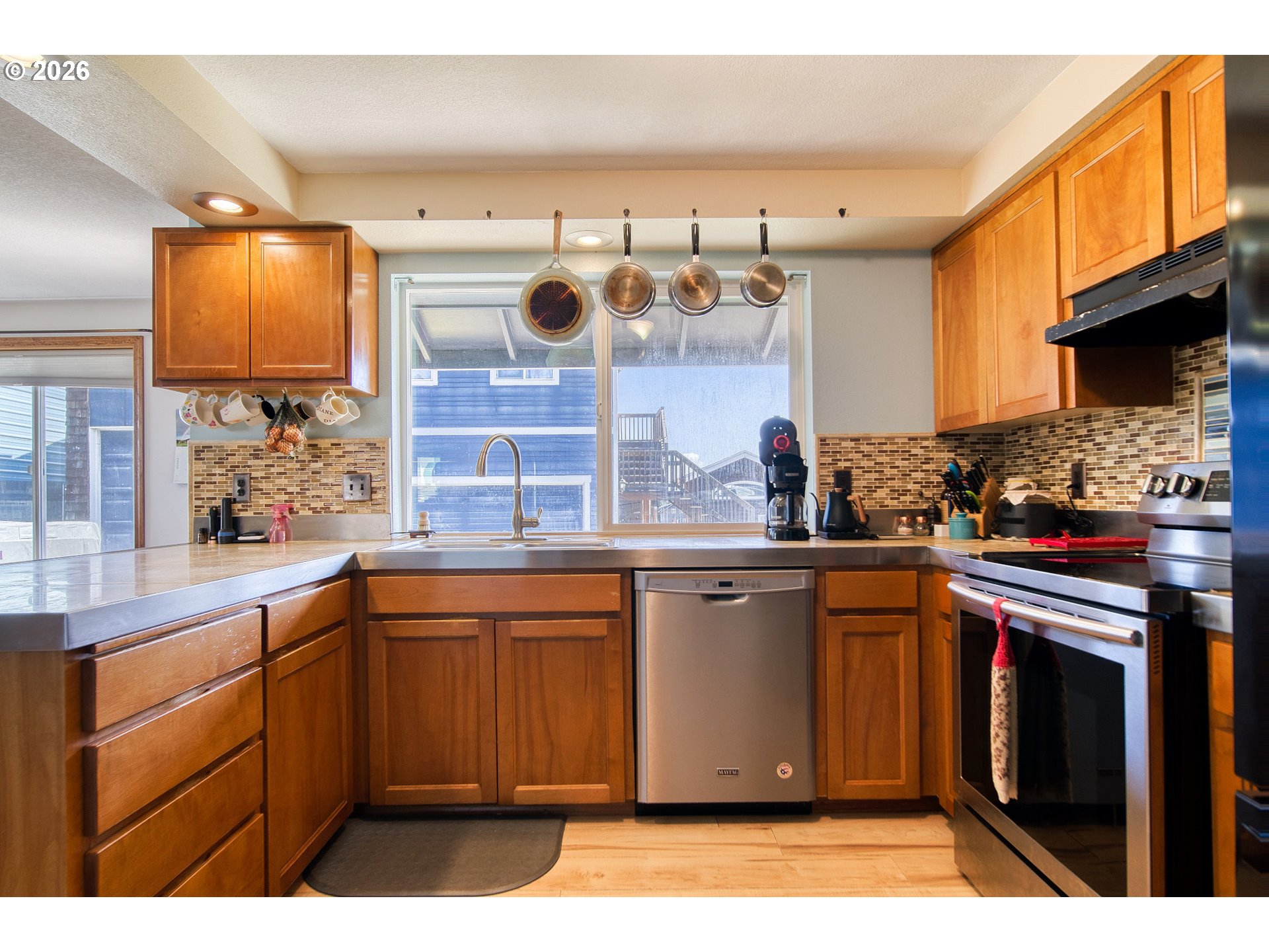 52320 Southwest Taylor Street Scappoose, OR 97056 - Photo 10 of 48 a kitchen with stainless steel appliances granite countertop a sink a stove and a microwave