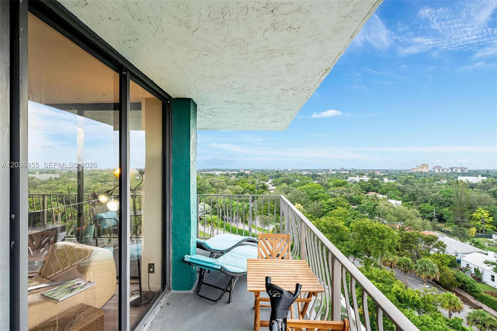 780 Northeast 69th Street, Unit 1010 Miami, FL 33138 - Photo 15 of 31 a view of a balcony with chairs and wooden fence