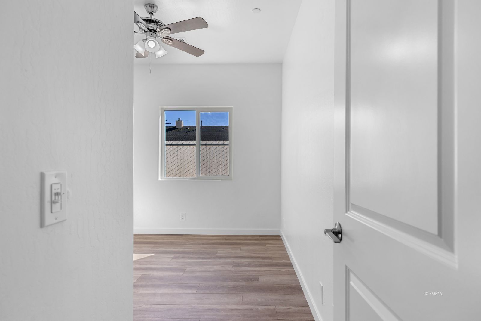 1112 Vulcan Ridgecrest, CA 93555 - Photo 20 of 30 a view of a hallway with wooden floor and chandelier