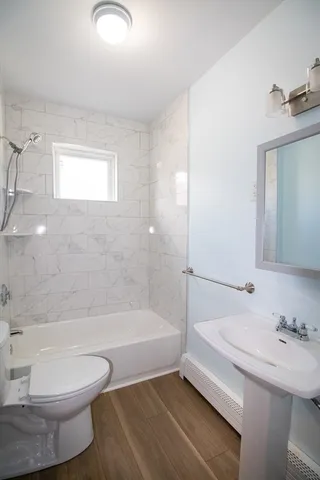 a bathroom with a sink a toilet and bathtub