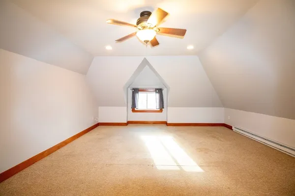 an empty room with a window and a ceiling fan