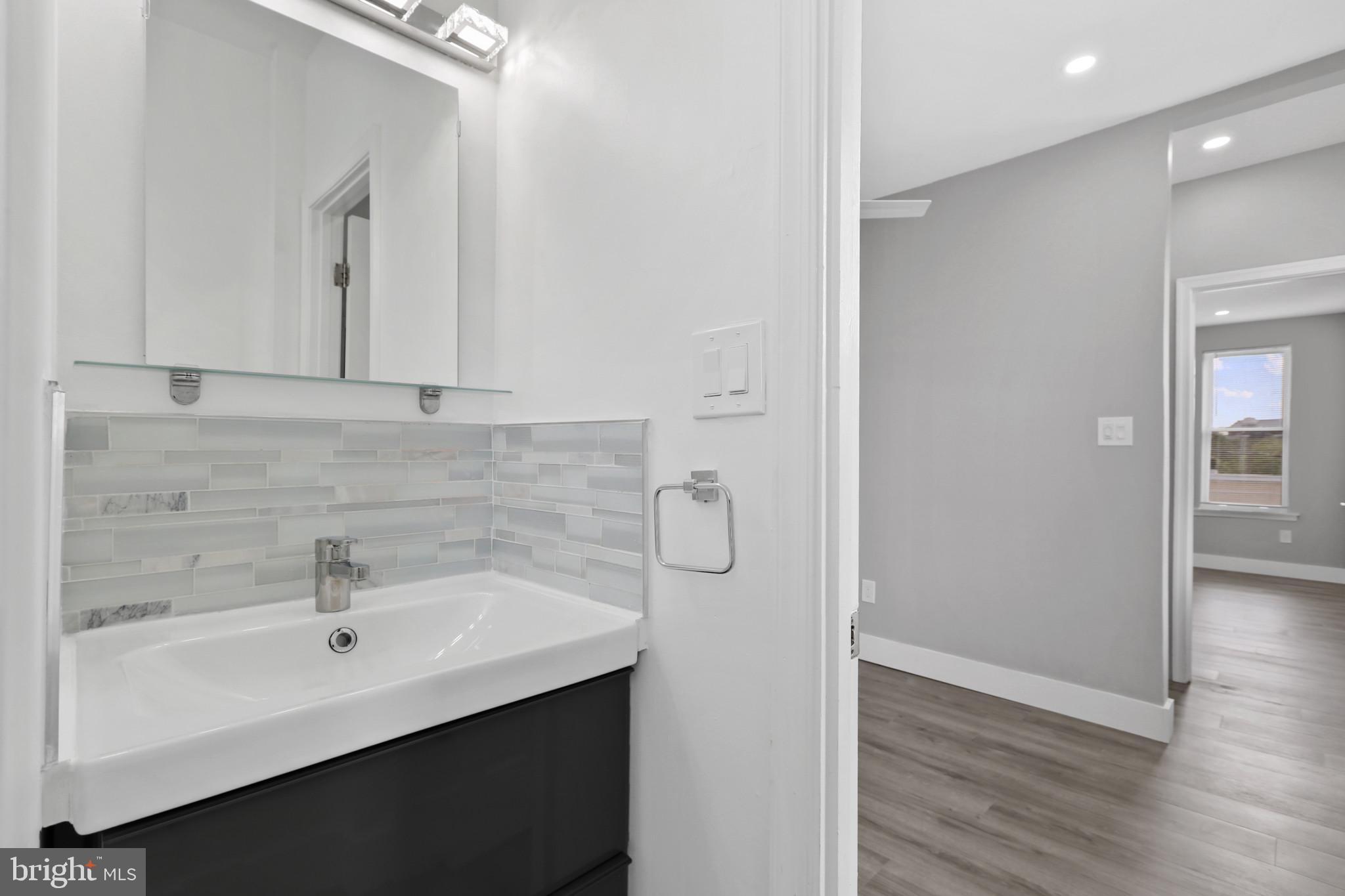 3600 Keswick Road, Unit B Baltimore, MD 21211 - Photo 12 of 23 a bathroom with a sink and a mirror