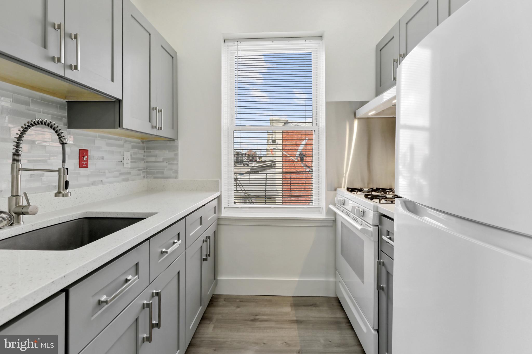 3600 Keswick Road, Unit B Baltimore, MD 21211 - Photo 13 of 23 a kitchen with granite countertop a sink and a refrigerator