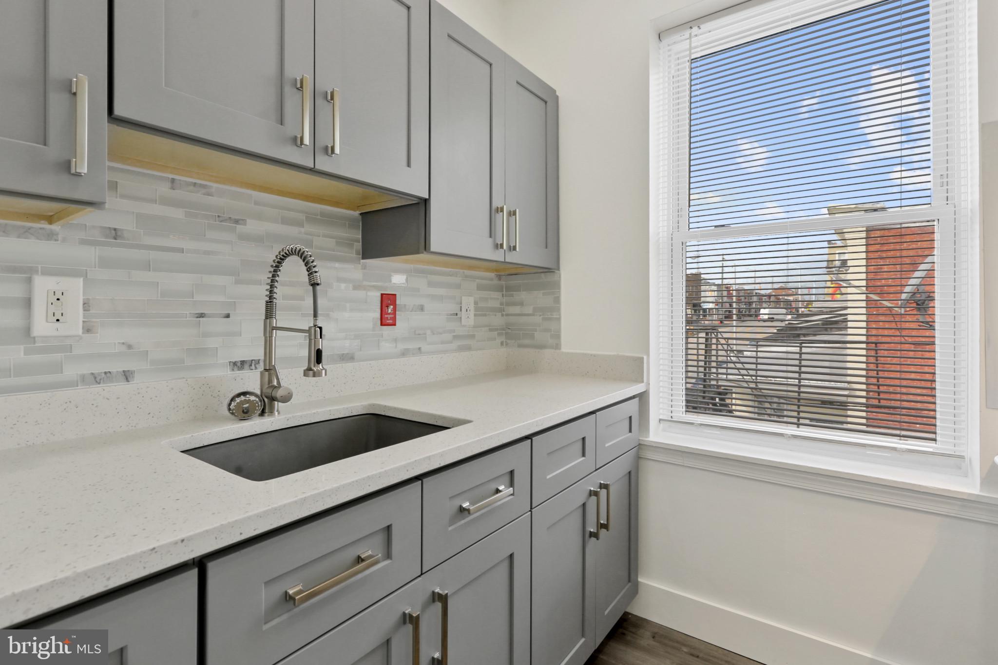 3600 Keswick Road, Unit B Baltimore, MD 21211 - Photo 14 of 23 a kitchen with stainless steel appliances granite countertop a sink and a window