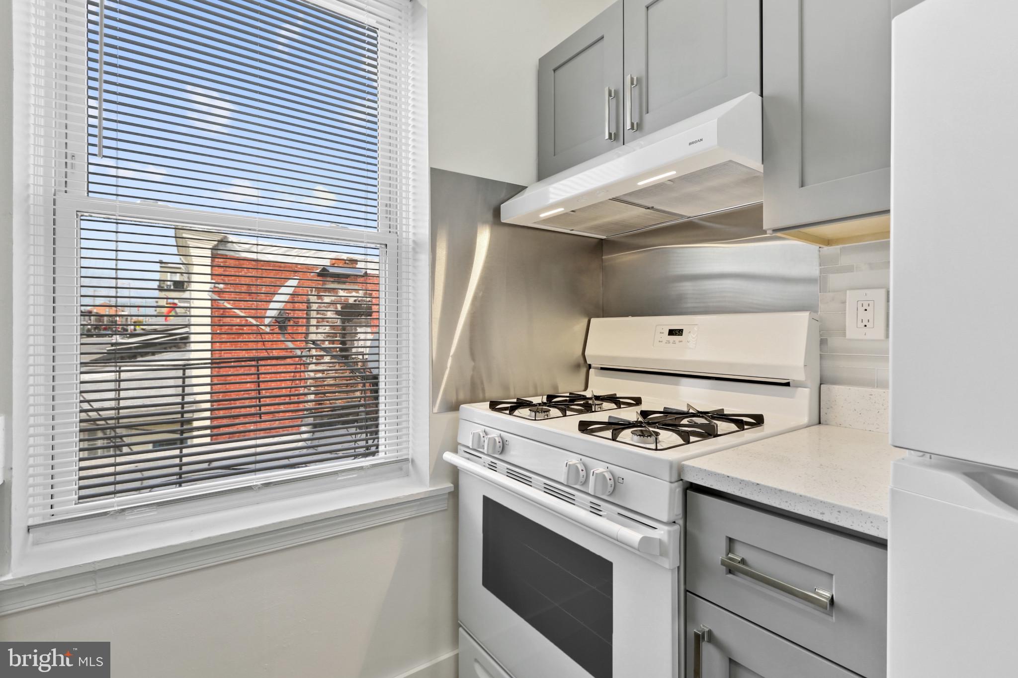 3600 Keswick Road, Unit B Baltimore, MD 21211 - Photo 16 of 23 a kitchen with stove and cabinets