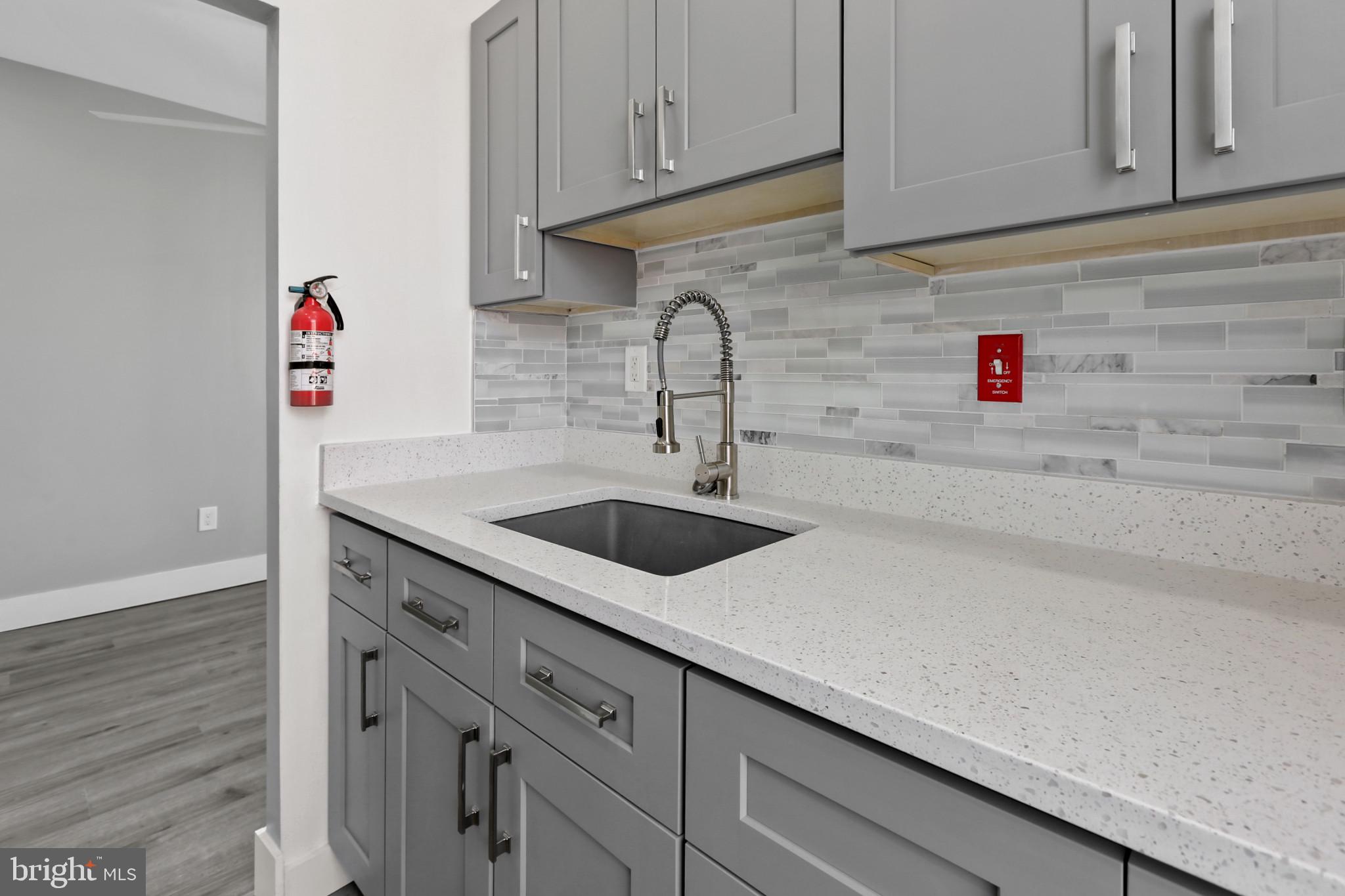 3600 Keswick Road, Unit B Baltimore, MD 21211 - Photo 18 of 23 a sink with cabinets and wooden floor