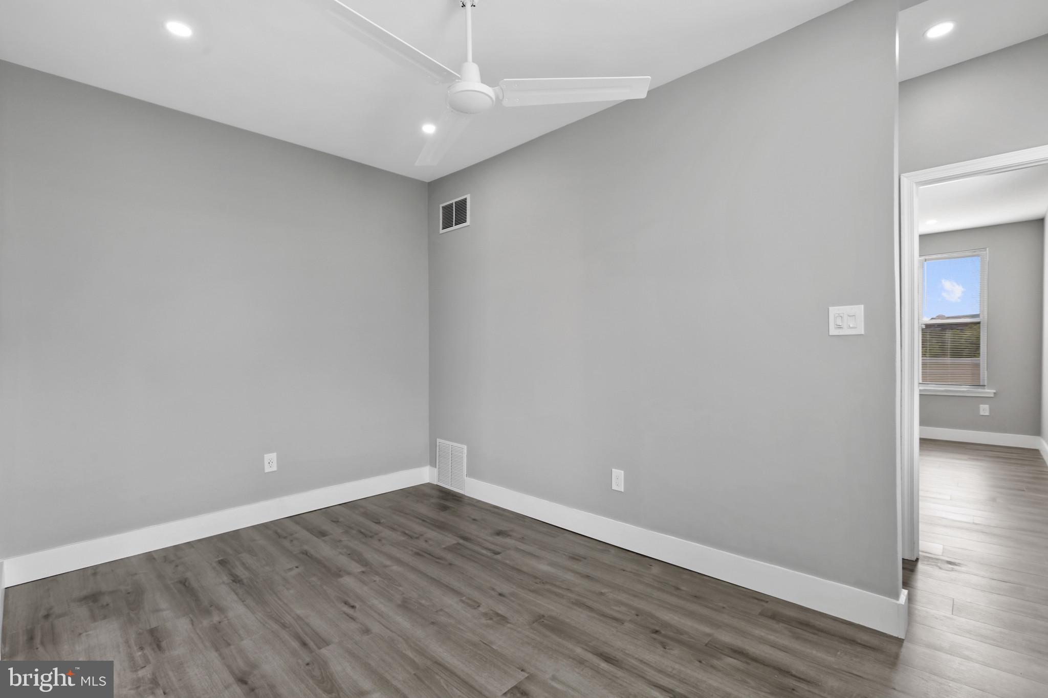 3600 Keswick Road, Unit B Baltimore, MD 21211 - Photo 5 of 23 wooden floor in an empty room with a window